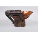 A Chinese section horn libation cup with carved decoration of figures in a landscape, 19 x 15cm,