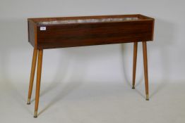 A mid-century planter with rosewood design, formica sides, pine lined with a metal liner, raised