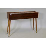 A mid-century planter with rosewood design, formica sides, pine lined with a metal liner, raised