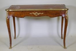 A French marquetry inlaid bureau plat, with shaped top, single drawer and ormolu mounts, bears label