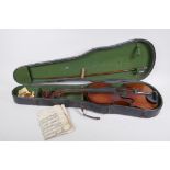 An antique violin and bow in case, violin back 36 cm long