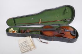 An antique violin and bow in case, violin back 36 cm long