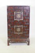 An oriental hardwood cabinet with brass mounts and auspicious character decoration, foot loose, 56 x