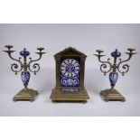 A C19th French bronze and enamelled porcelain clock garniture, the hand painted dialÿ with mask