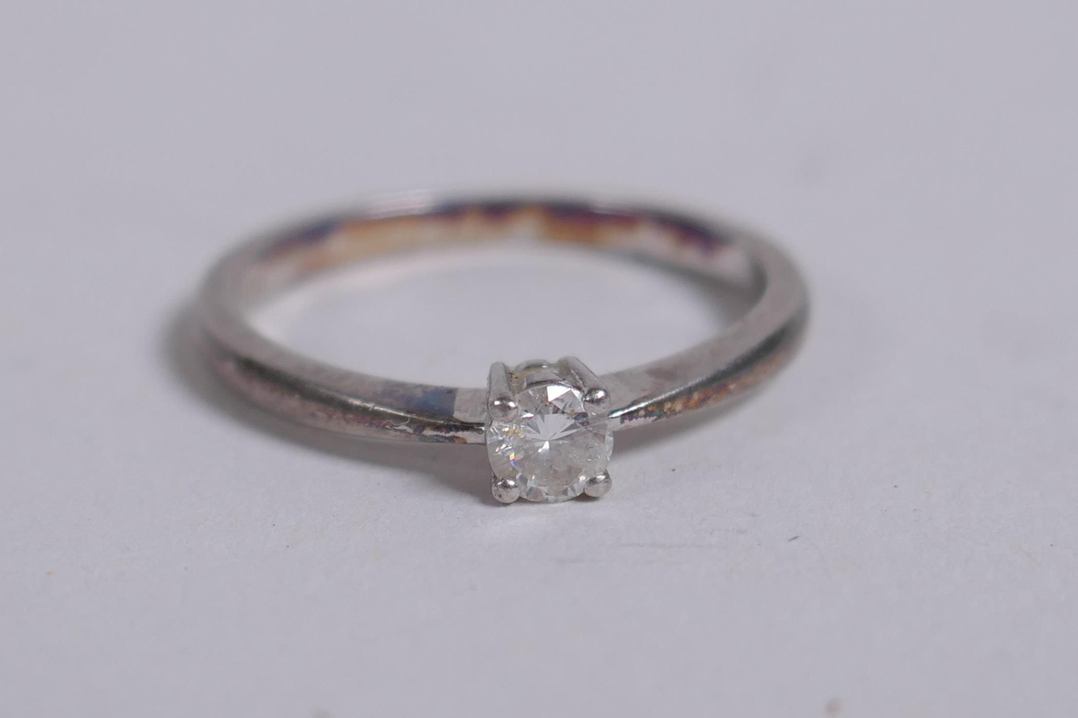 A platinum and diamond solitaire ring, size N approx