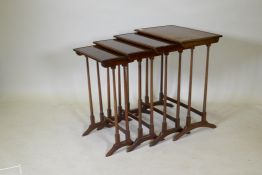 A quartetto nest of mahogany occasional tables, with beaded tops, raised on slender turned