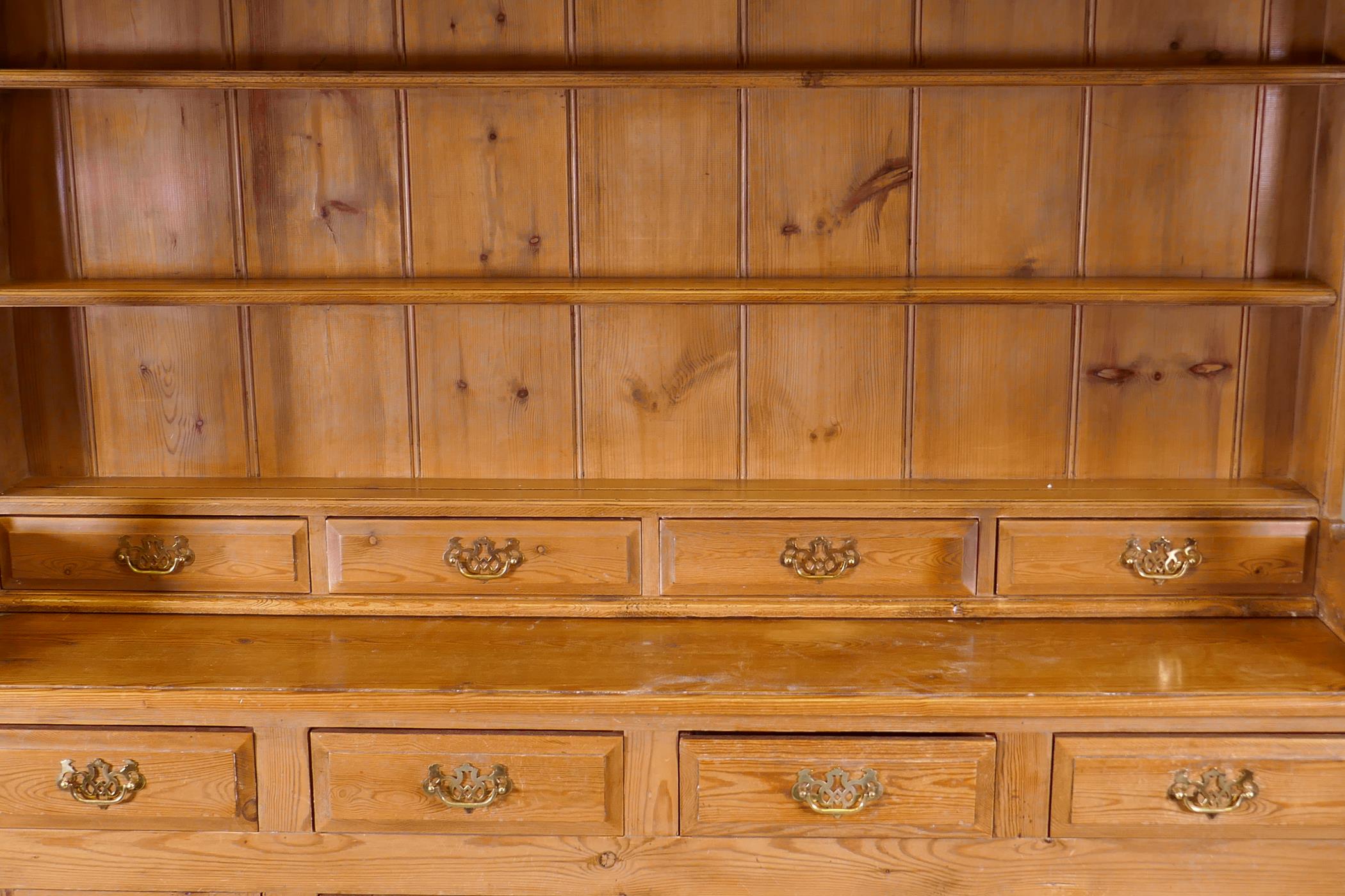 A pine dresser, the upper section with delft rack over four drawers, open sides, the base with - Image 3 of 5