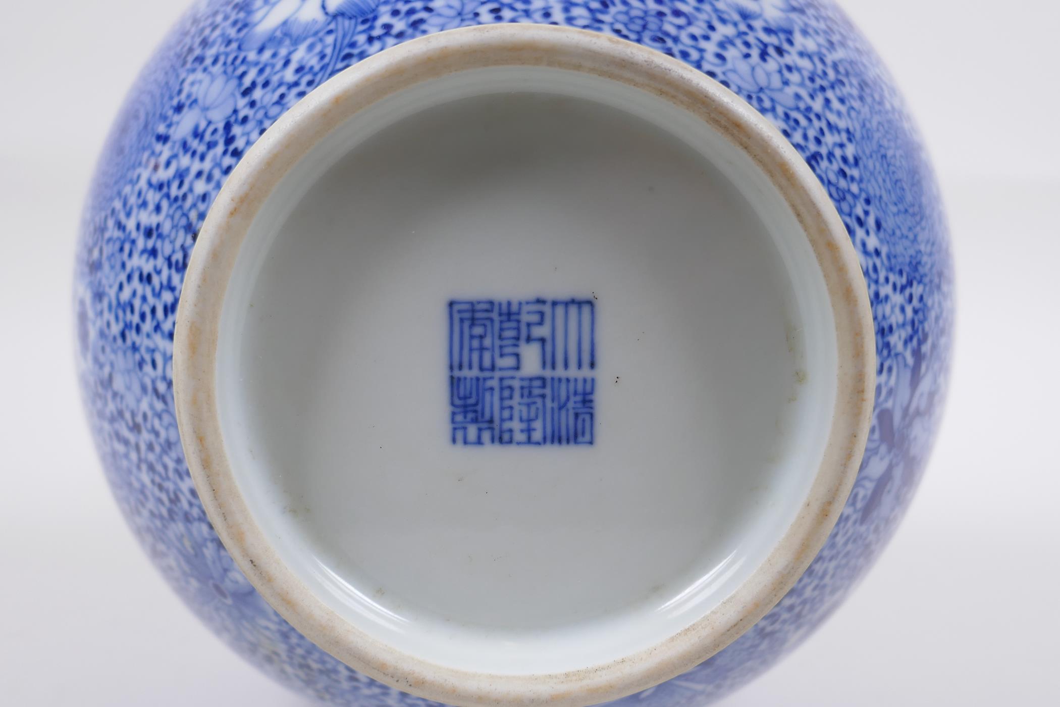 A blue and white porcelain vase with decorative panels depicting landscape scenes, in decorative - Image 5 of 6