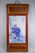 A Chinese Republic blue and white porcelain plaque depicting figures in a landscape, mounted in a