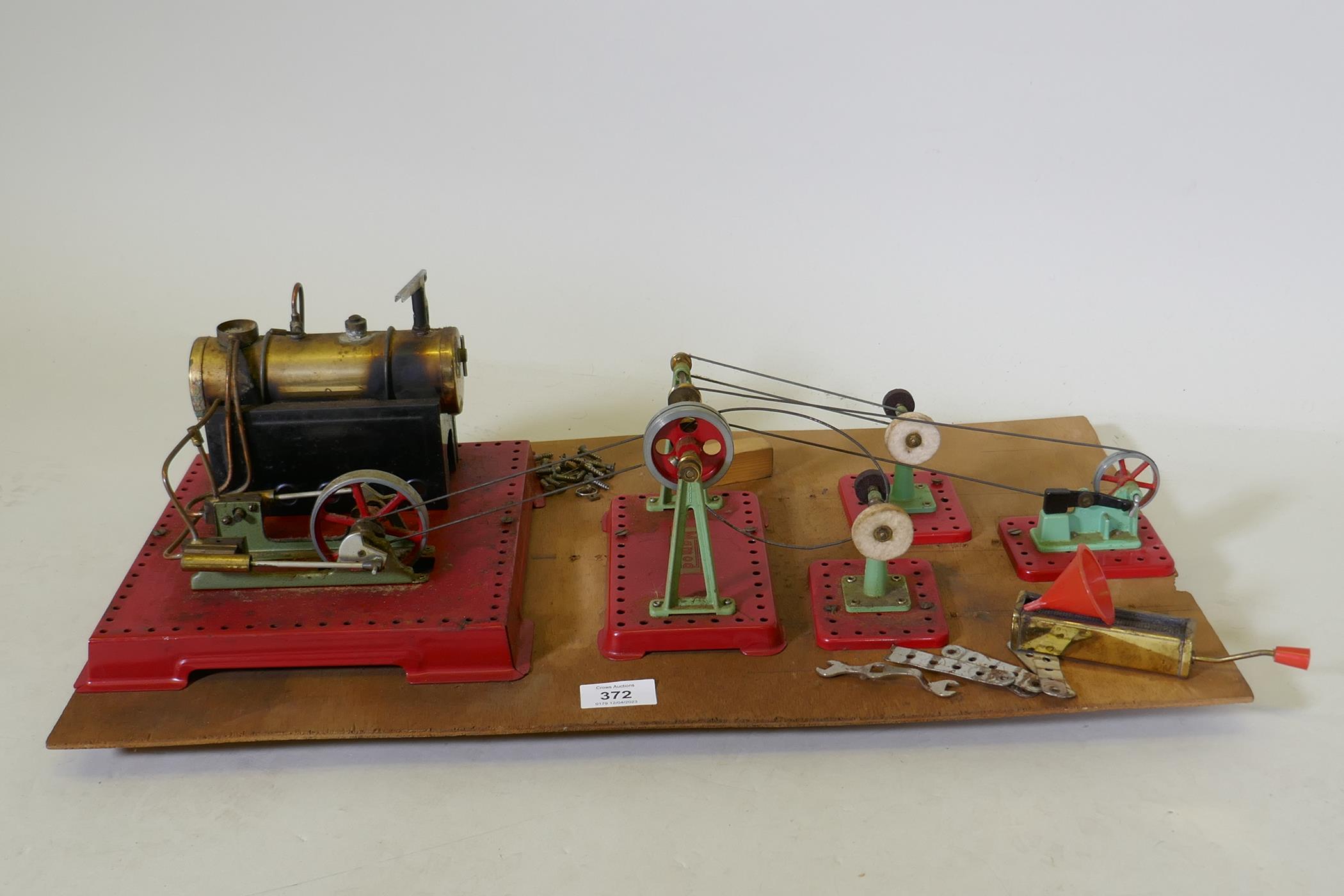 A Mamod steam driven workshop, mounted on a wood board, 60 x 35cm