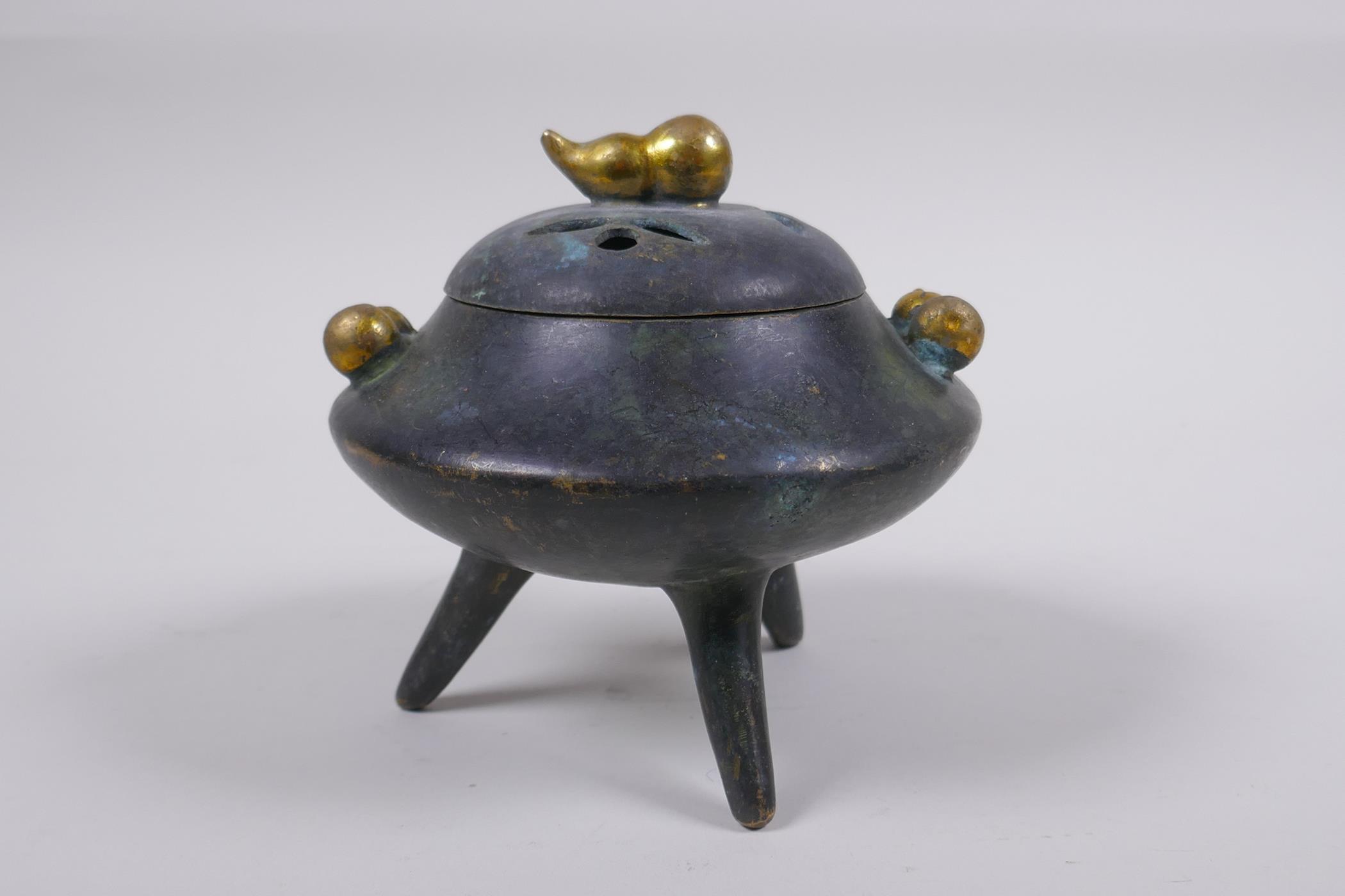 A Chinese bronze censer and cover on tripod supports with gilt gourd handles and knop impressed seal - Image 3 of 5