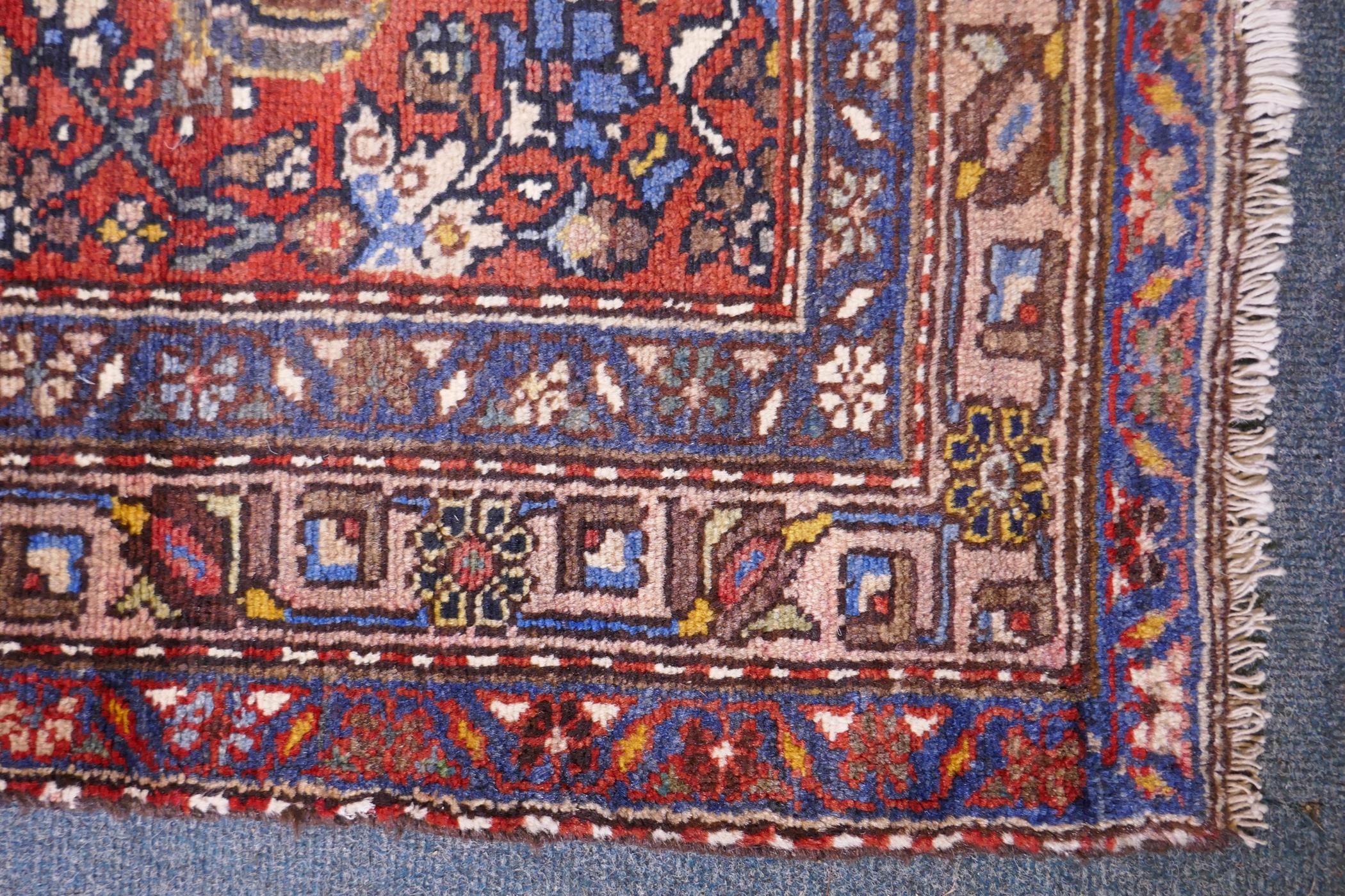 A hand woven red ground Persian Hamadan nomadic runner with an allover floral design, 102 x 310cm - Image 5 of 6