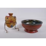 A studio pottery bowl with an iron red glaze to the exterior and hares fur style glaze to the