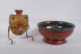 A studio pottery bowl with an iron red glaze to the exterior and hares fur style glaze to the