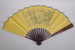 A Chinese bamboo and silk fan with printed decoration of birds amongst branches in bloom, with