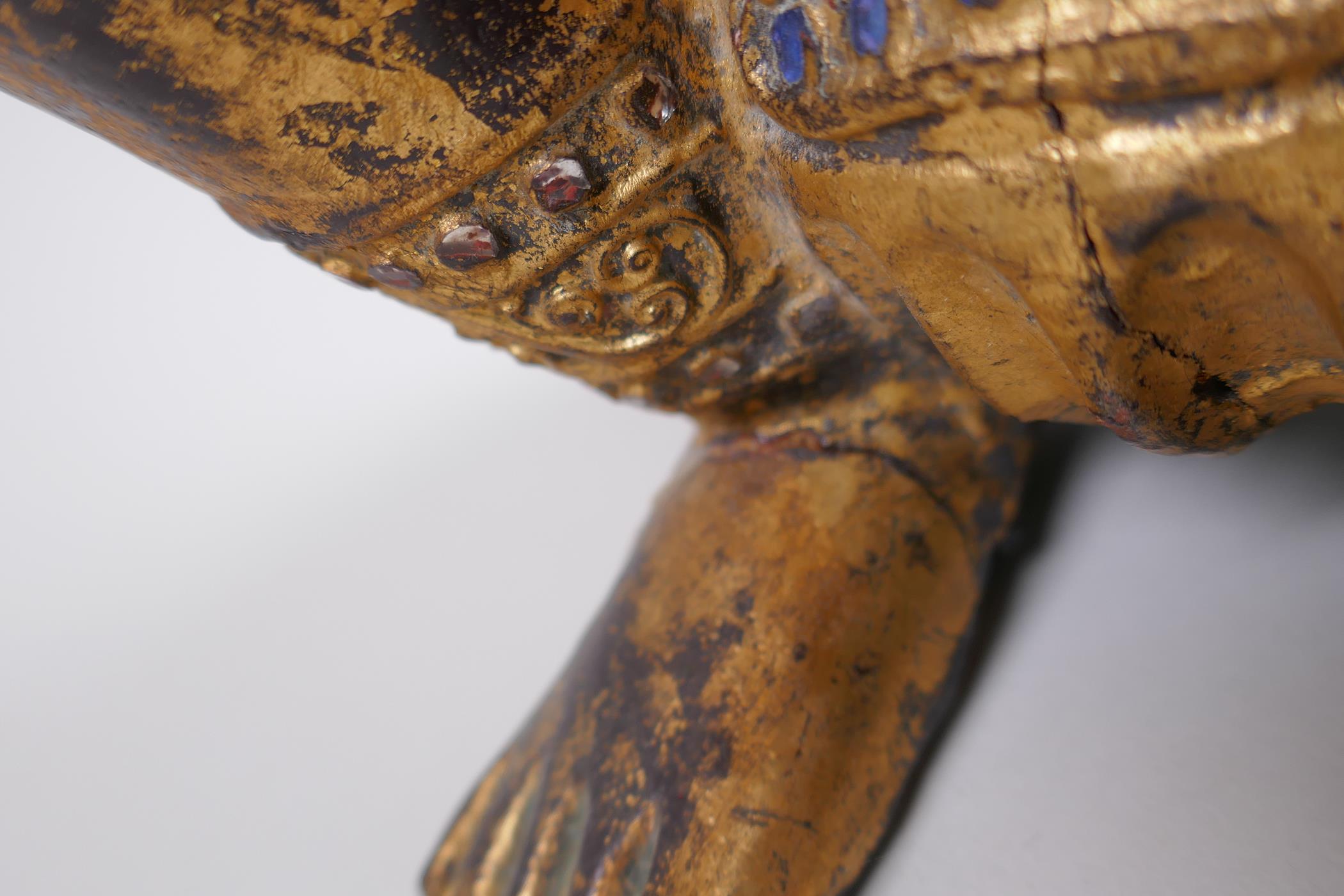 A Tibetan carved gilt and painted wood figure of a musician with inset glass decoration, 38cm - Image 4 of 6