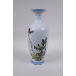 A Chinese famille verte enamelled porcelain vase decorated with two birds amongst flowers,
