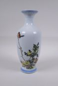 A Chinese famille verte enamelled porcelain vase decorated with two birds amongst flowers,