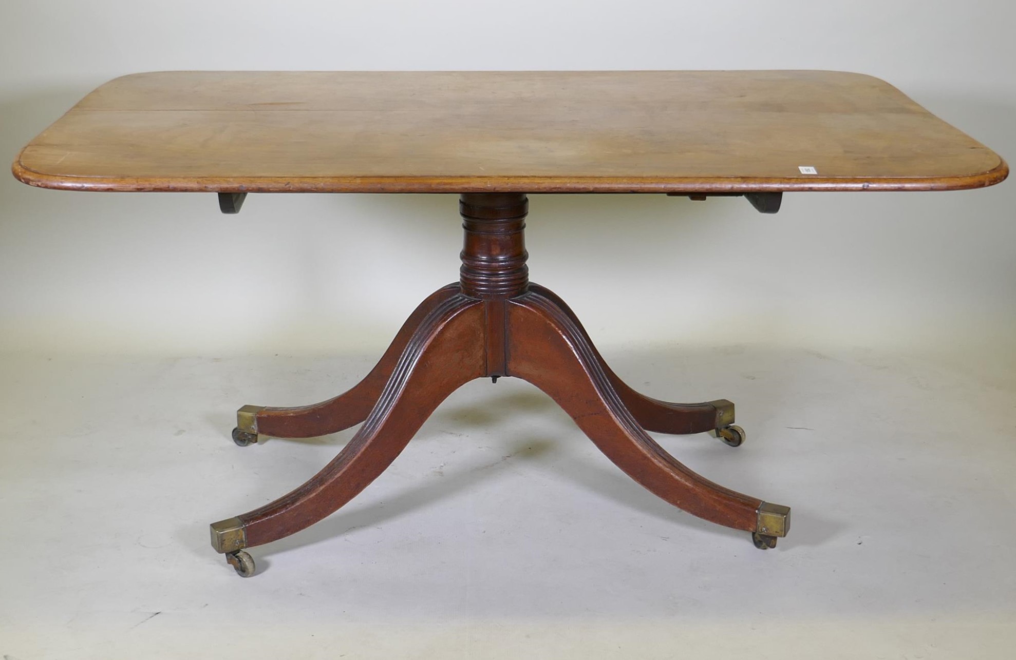 A mahogany breakfast table with an associated top, 95 x 148cm, 73cm high