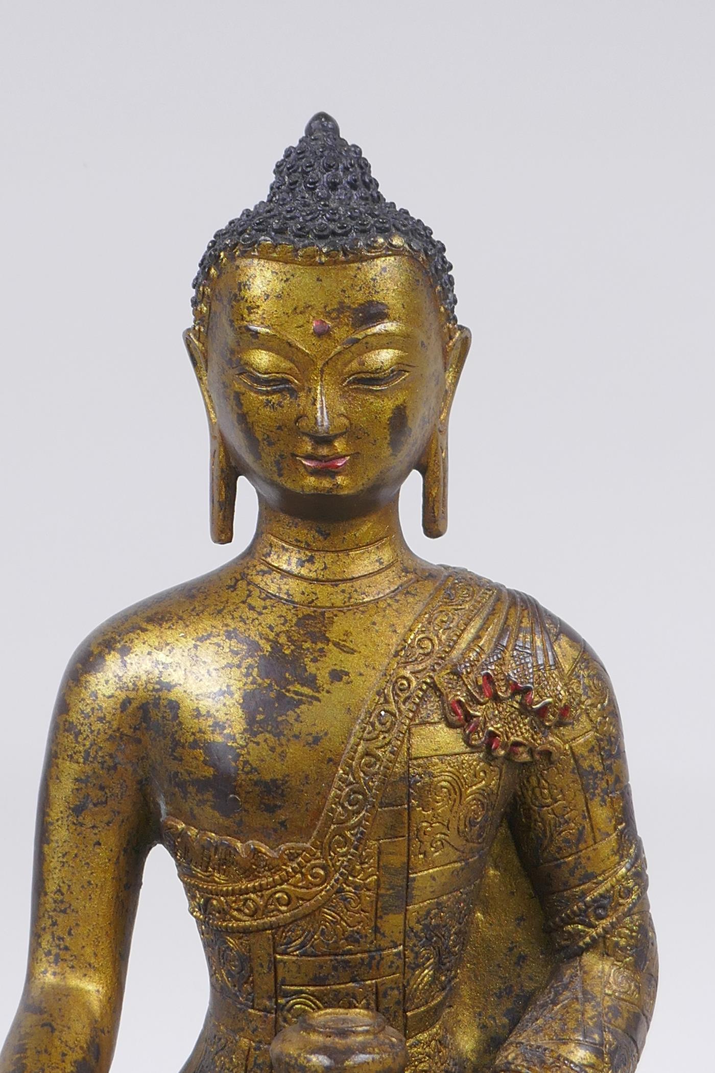 A Sino Tibetan filled gilt bronze figure of Buddha, impressed double vajra mark to base, 30cm high - Image 2 of 6