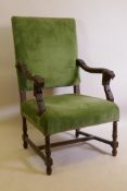 A C19th high back open arm chair with carved lion mask arms, raised on turned supports, AF