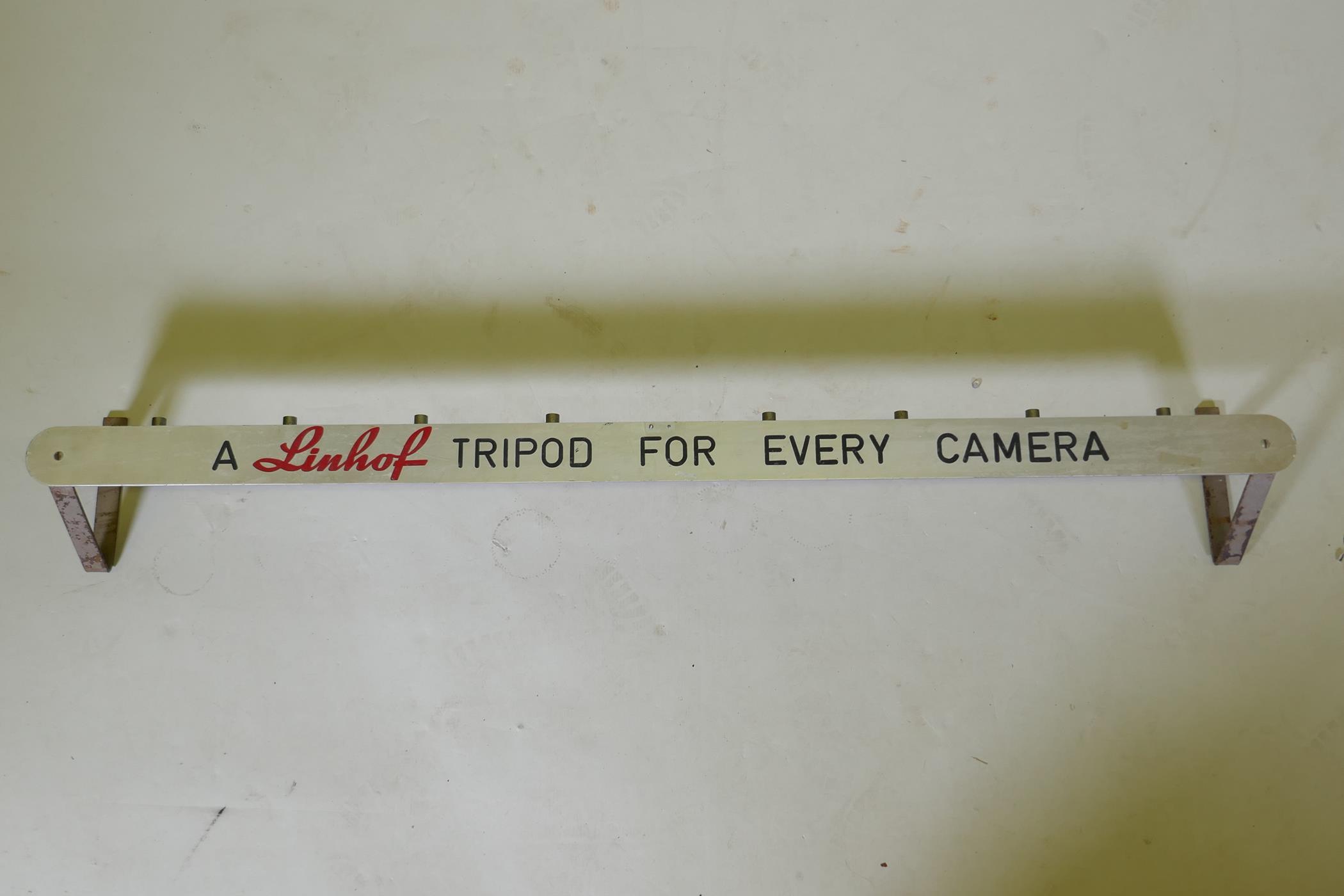 A 'Linhof Tripod for Every Camera' advertising wall mount, 125cm long