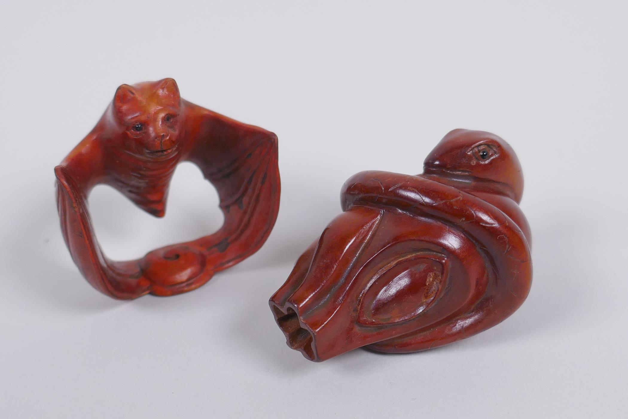 Two Japanese carved boxwood netsuke in the form of a snake and a bat, signed, 5cm long