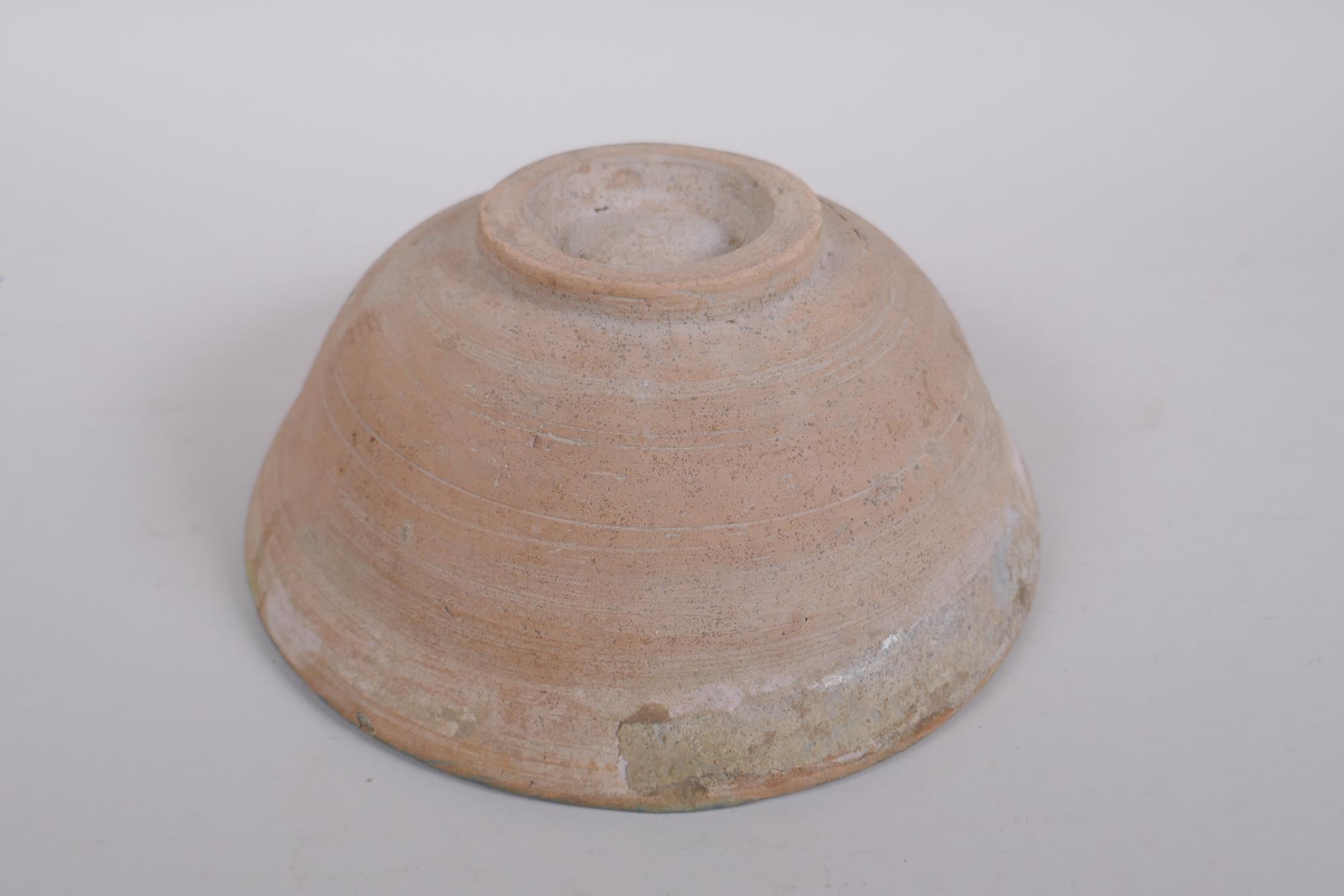 A middle eastern terracotta bowl with blue and white glazed decoration to the interior, 20cm - Image 3 of 5
