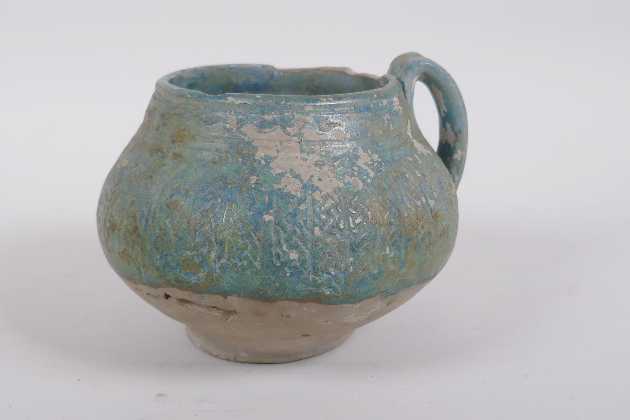 An antique turquoise slip glazed terracotta pot with a single handle, historic repairs, 14cm - Image 3 of 7