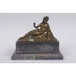 A Grand Tour silver plated ink well with bronze mount in the form of a reclining Greco-Roman figure,