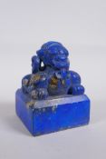 A Chinese reconstituted blue hardstone seal with a kylin knop, 9 x 9cm, 12cm high