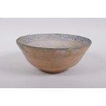 A middle eastern terracotta bowl with blue and white glazed decoration to the interior, 20cm