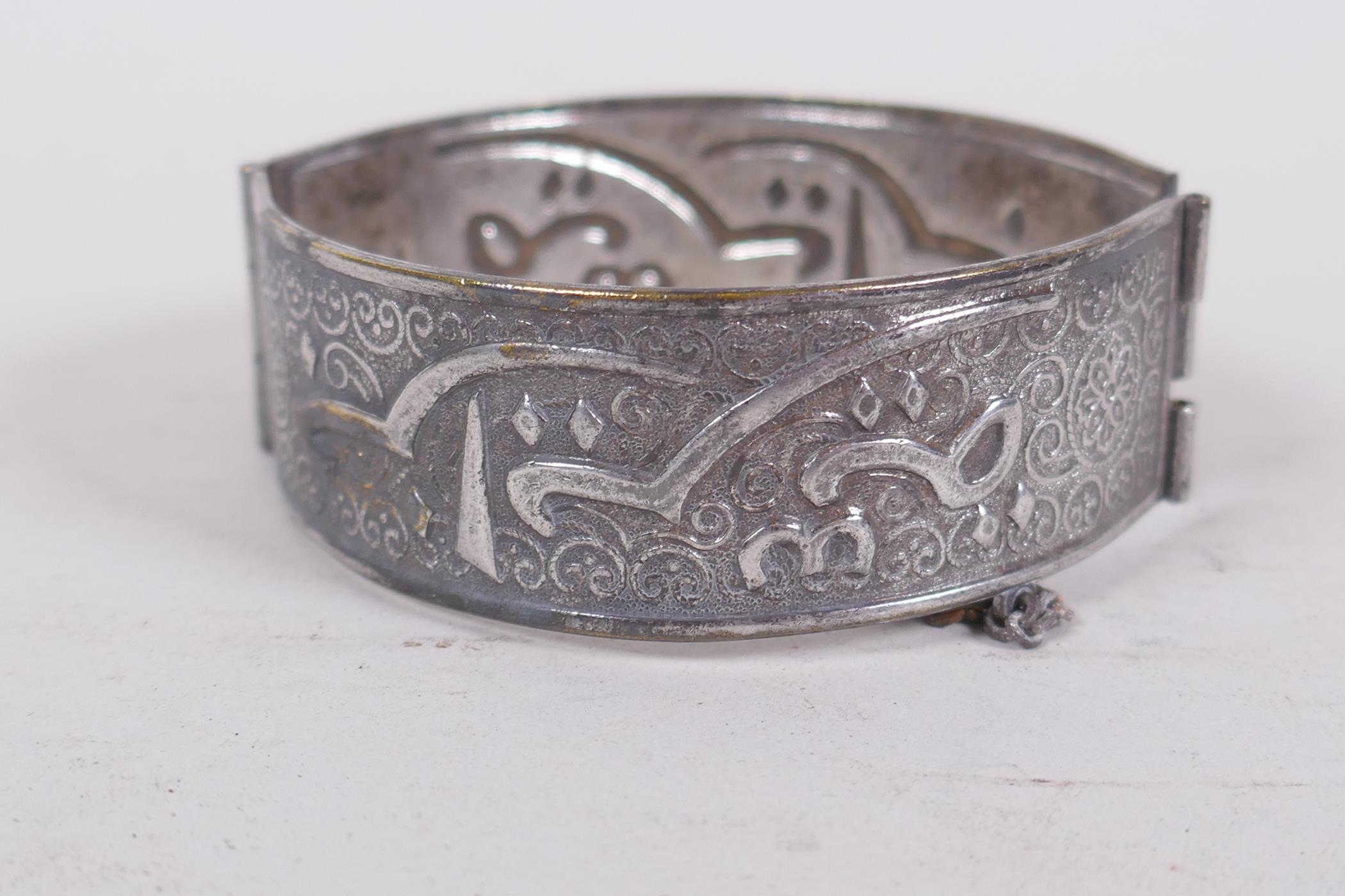 An Algerian silver bangle, inset with turquoise stones, 6cm diameter, and a similar white metal link - Image 3 of 5
