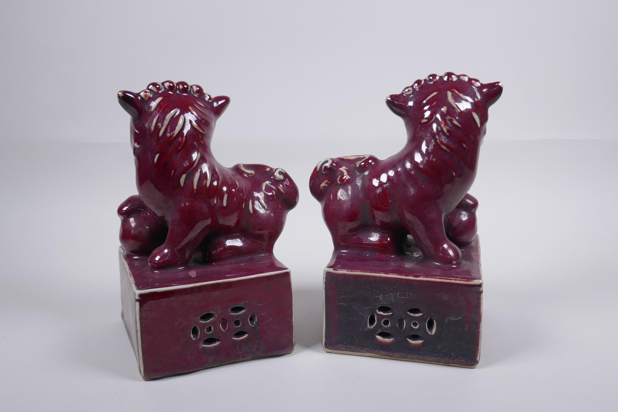 A pair of sang de boeuf glazed porcelain fo dogs, Chinese Xuande 6 character mark, 21cm high - Image 2 of 4