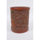 A Chinese carved bamboo brush pot decorated with figures in a landscape, 16cm high