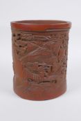 A Chinese carved bamboo brush pot decorated with figures in a landscape, 16cm high