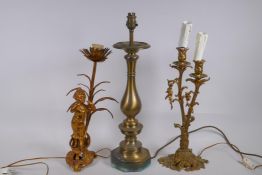 A gilt metal figural and floral lamp, a two branch brass lamp and a spun brass table lamp, largest