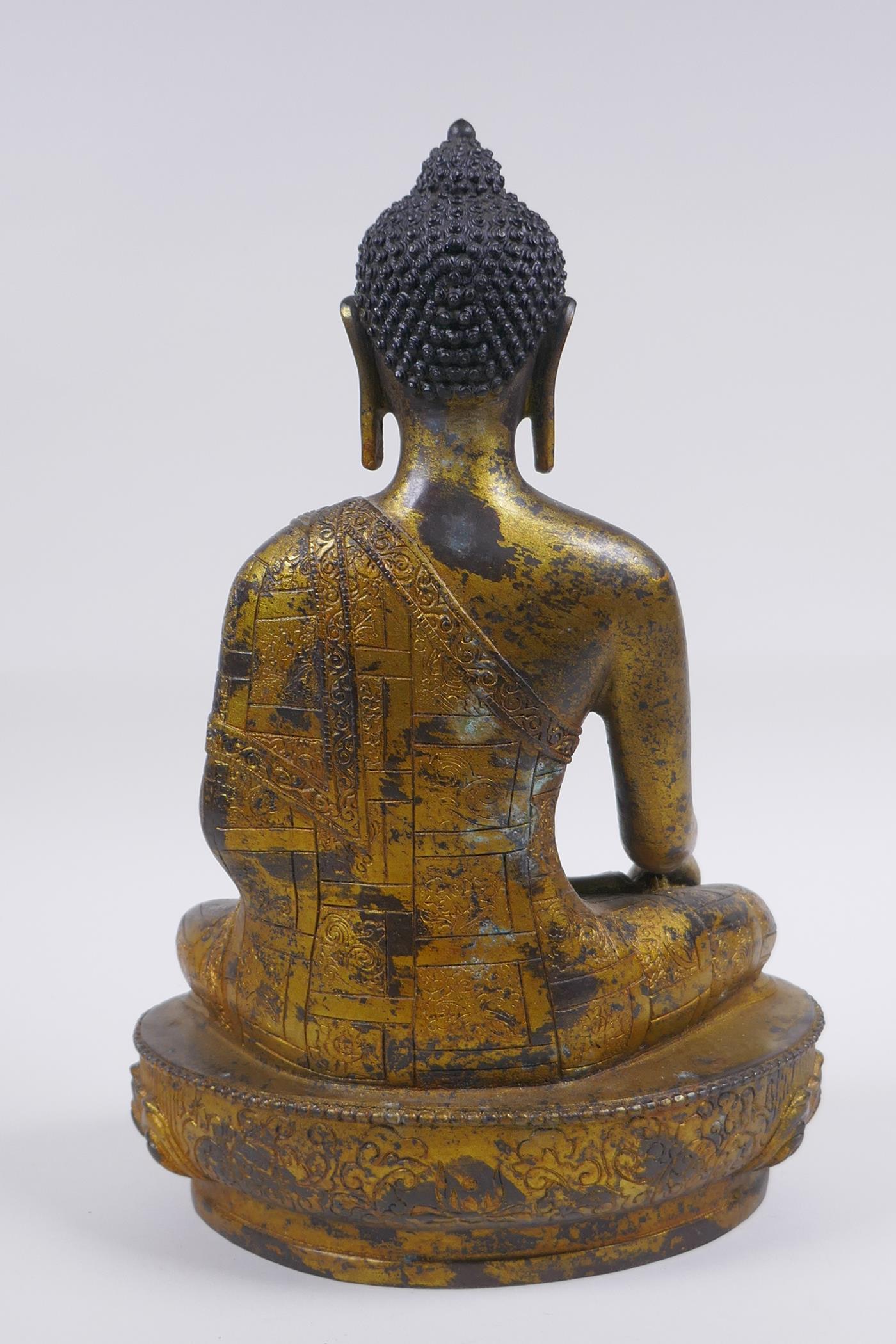 A Sino Tibetan filled gilt bronze figure of Buddha, impressed double vajra mark to base, 30cm high - Image 4 of 6