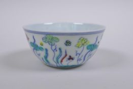 A Doucai porcelain tea bowl with lotus pond decoration, Chinese Chenghua 6 character mark to base,