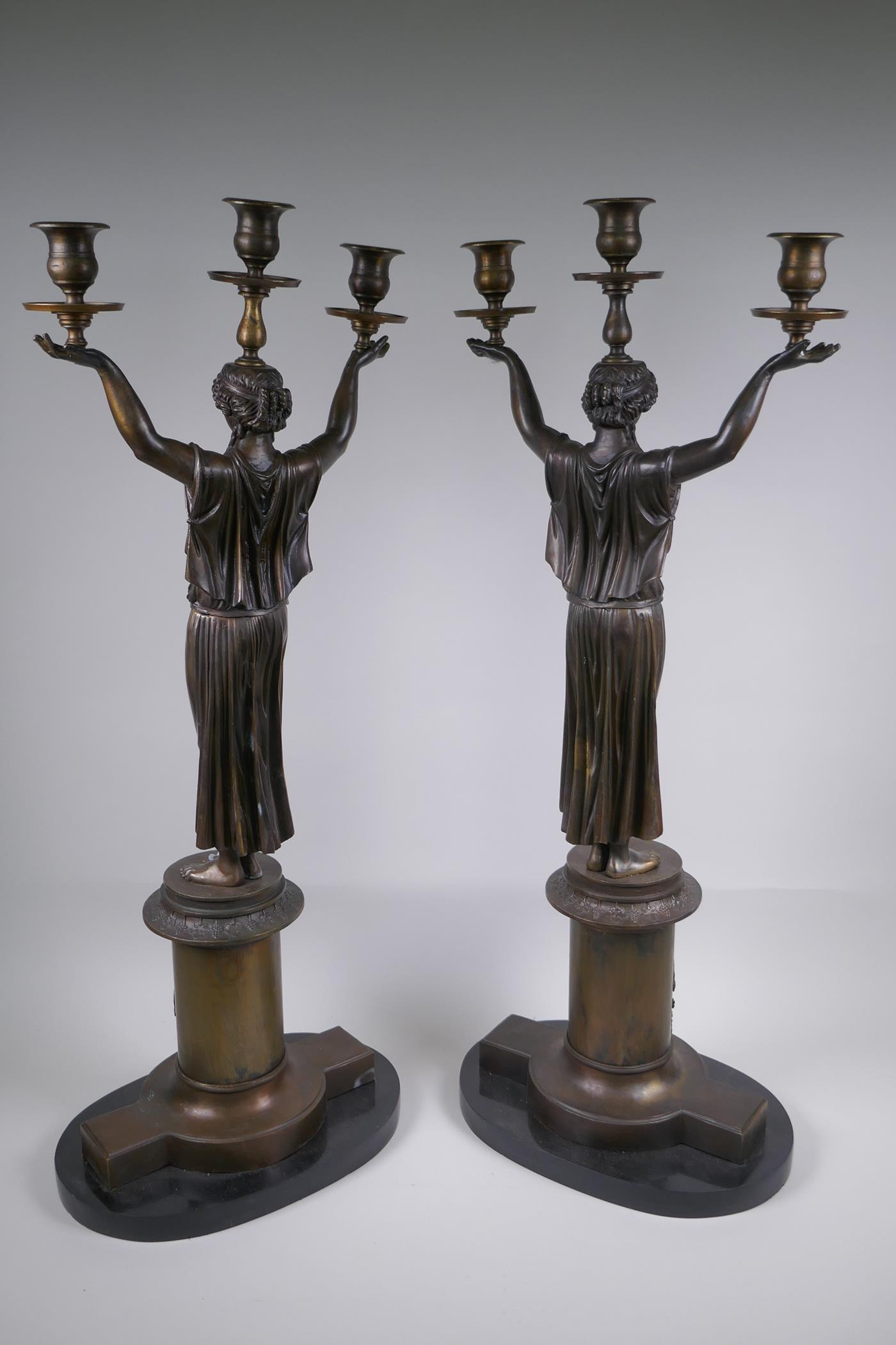 A pair of Empire style bronze three branch figural candlesticks in the form of classical women, 74cm - Image 7 of 7