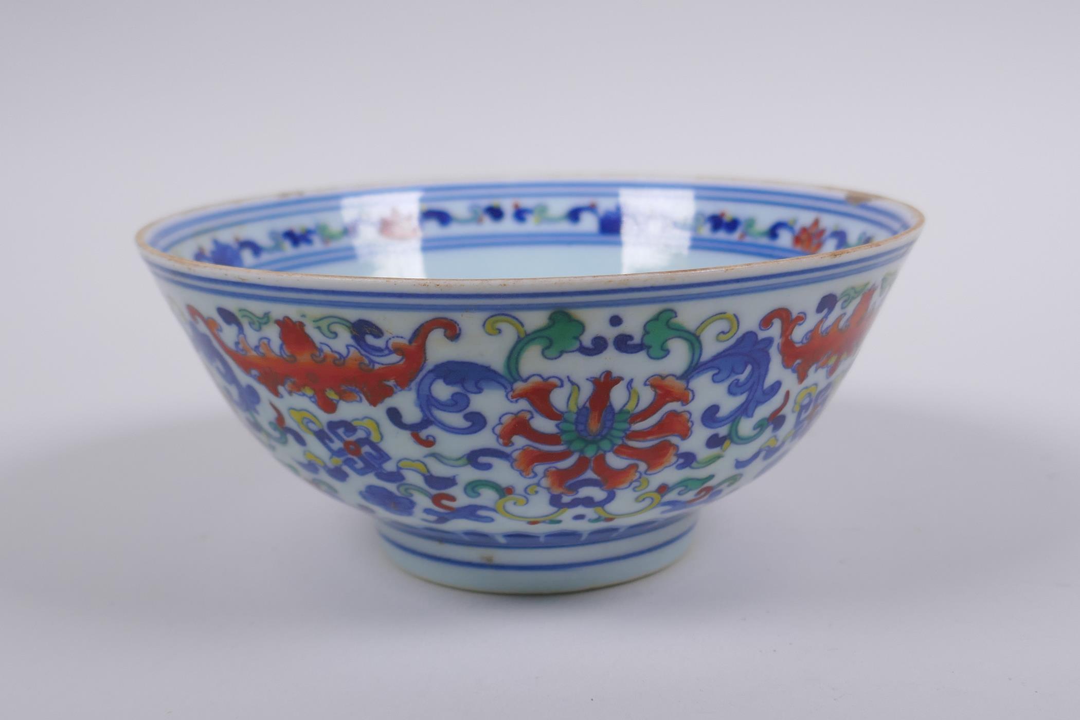 A Chinese wucai porcelain rice bowl decorated with bats and lotus flowers, YongZheng 6 character