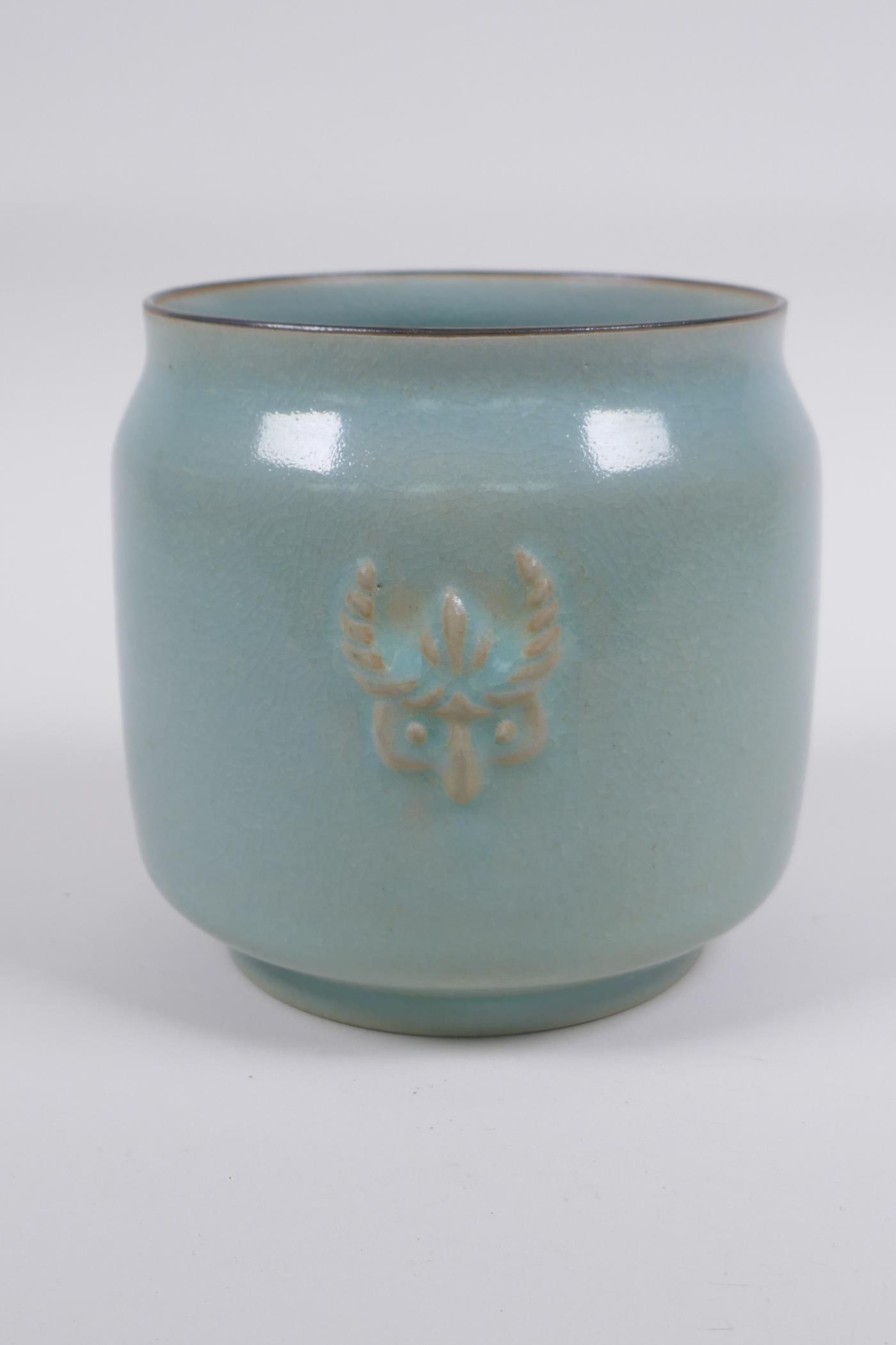 Chinese Ru ware style celadon glazed jar with twin mask decoration, 12cm high x 12cm diameter