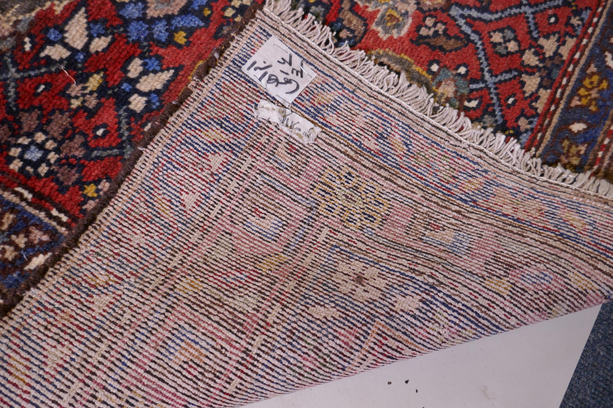 A hand woven red ground Persian Hamadan nomadic runner with an allover floral design, 102 x 310cm - Image 6 of 6