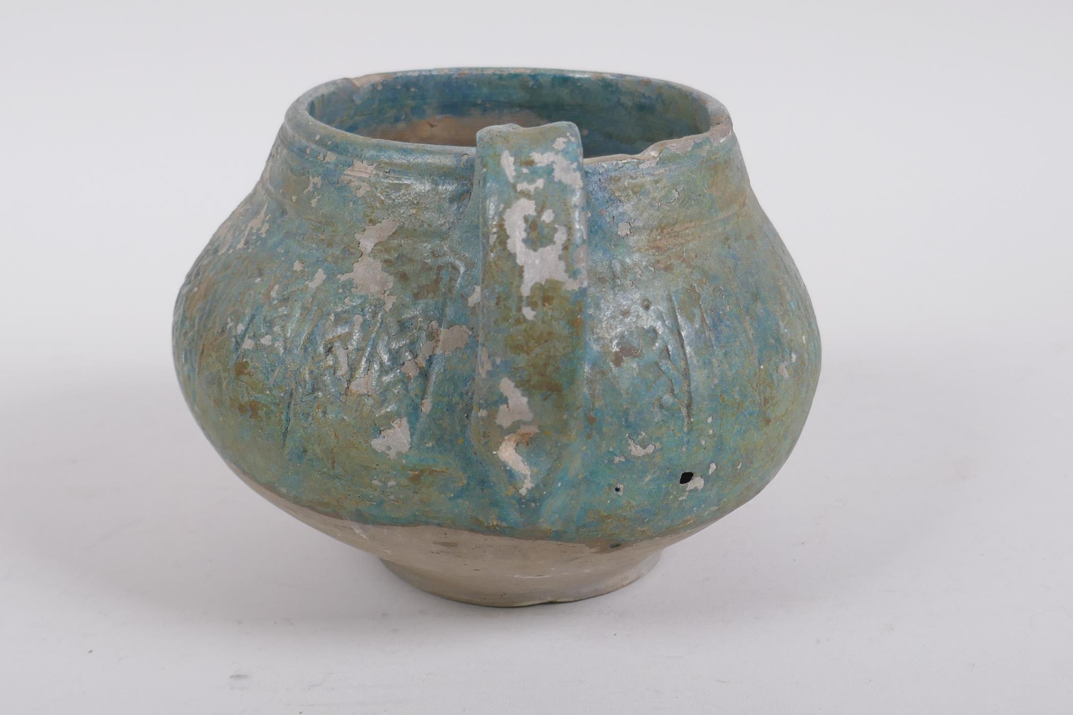 An antique turquoise slip glazed terracotta pot with a single handle, historic repairs, 14cm - Image 4 of 7