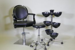 An Ayala 'Royal' hydraulic salon styling chair in black, and adjustable chrome stool on castors, and