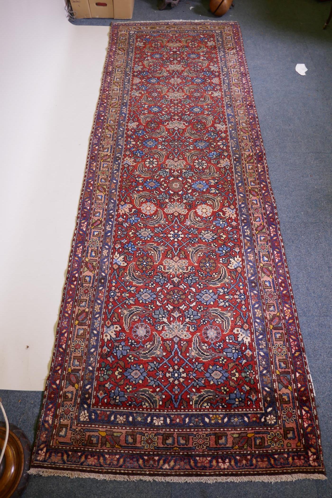 A hand woven red ground Persian Hamadan nomadic runner with an allover floral design, 102 x 310cm - Image 4 of 6