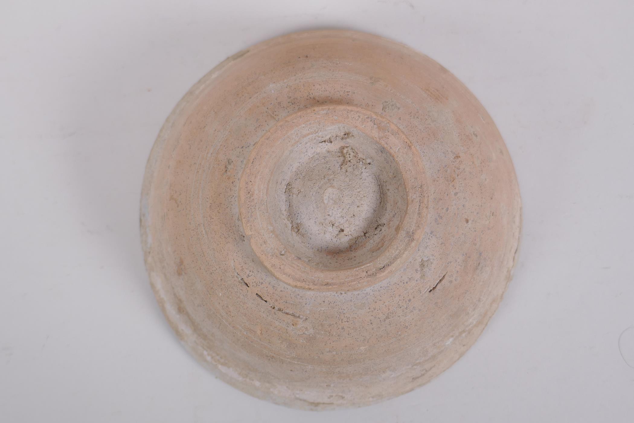 A middle eastern terracotta bowl with blue and white glazed decoration to the interior, 20cm - Image 5 of 5