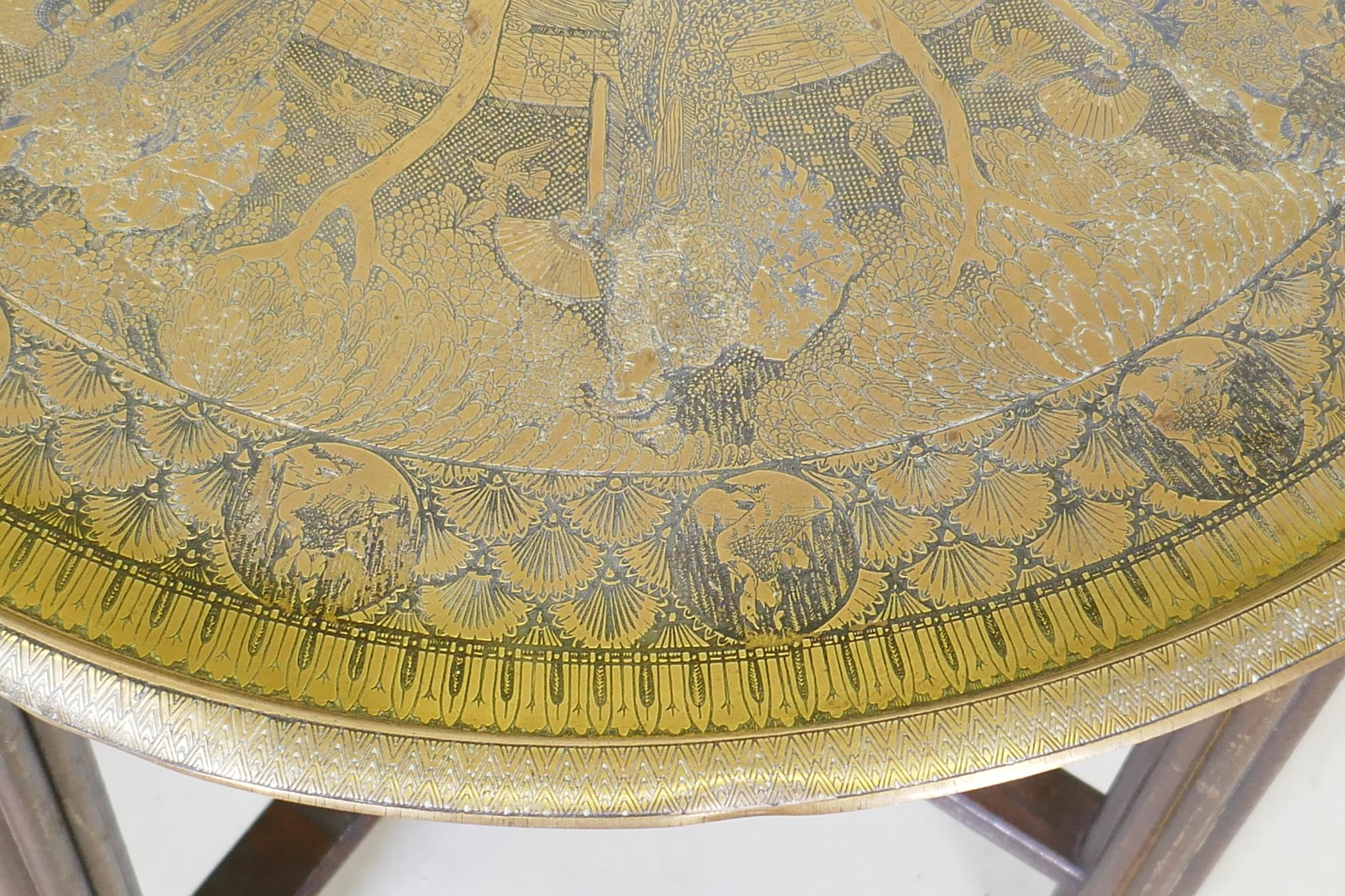 A Victorian brass top table with Japanese inspired decoration, on a folding wood base, 59 dia. x - Image 5 of 7
