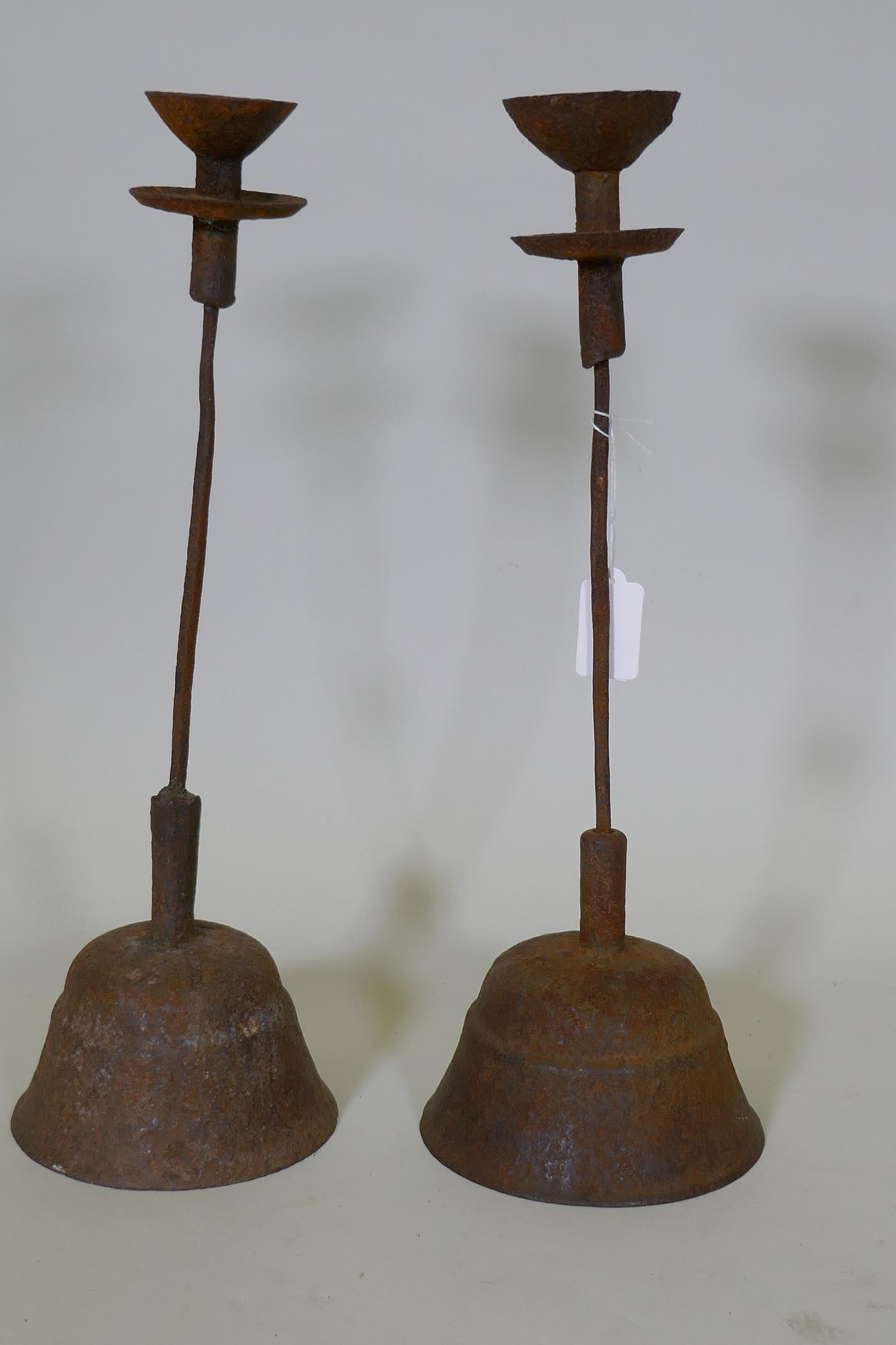 A pair of antique cast iron candlesticks, 42cm high