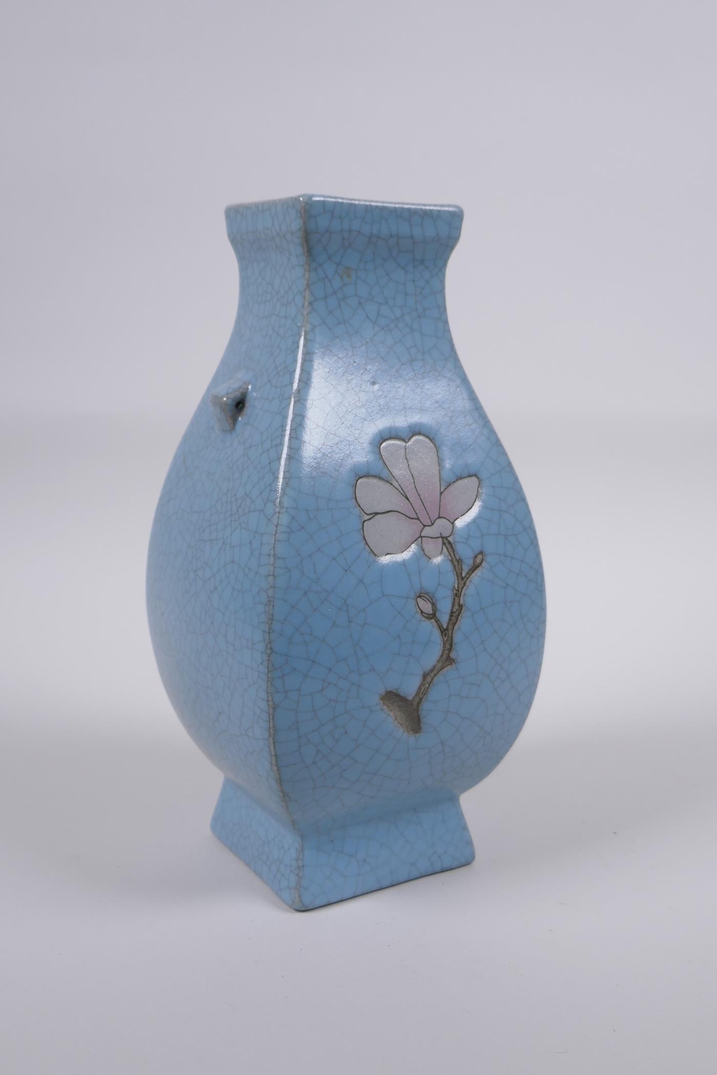 A Chinese celadon crackle glazed porcelain vase with two handles and floral decoration, 21cm high